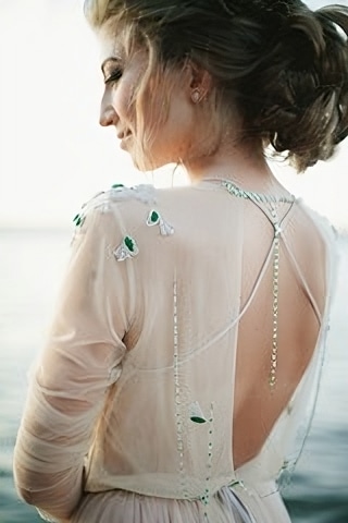 Femme portant une robe sublimée par des bijoux, vue de dos